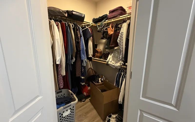 Overfilled closet before a Tidy Standard home organizing session