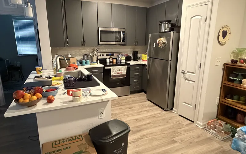 Cluttered kitchen counters before a Tidy Standard deep cleaning